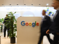 People walk past a Google stand during the Warsaw Security Forum 2024 in Warsaw, Poland on October 2, 2024. WSF2024, entitled 'Ensuring Secu...