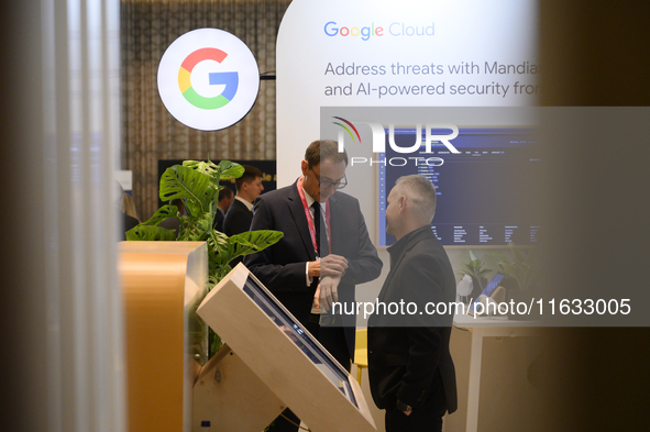 People talk in a Google stand during the Warsaw Security Forum 2024 in Warsaw, Poland on October 2, 2024. WSF2024, entitled 'Ensuring Securi...