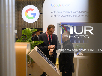 People talk in a Google stand during the Warsaw Security Forum 2024 in Warsaw, Poland on October 2, 2024. WSF2024, entitled 'Ensuring Securi...