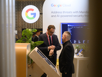 People talk in a Google stand during the Warsaw Security Forum 2024 in Warsaw, Poland on October 2, 2024. WSF2024, entitled 'Ensuring Securi...