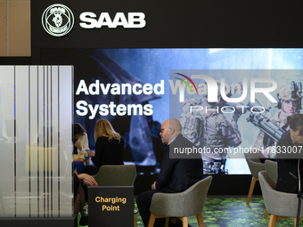 People sit at the SAAB AB lounge during the Warsaw Security Forum 2024 in Warsaw, Poland on October 2, 2024. WSF2024, entitled 'Ensuring Sec...