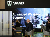 People sit at the SAAB AB lounge during the Warsaw Security Forum 2024 in Warsaw, Poland on October 2, 2024. WSF2024, entitled 'Ensuring Sec...