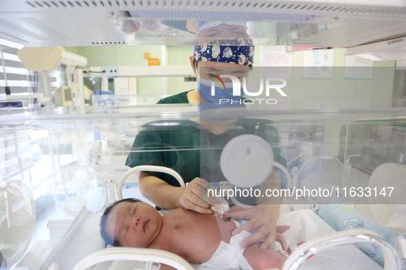 A medical staff member works at his post in the neonatology department of East Hospital in Lianyungang, China, on October 3, 2024. 