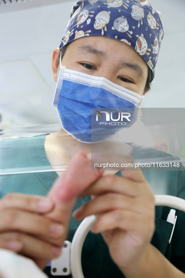 A medical staff member works at his post in the neonatology department of East Hospital in Lianyungang, China, on October 3, 2024. 