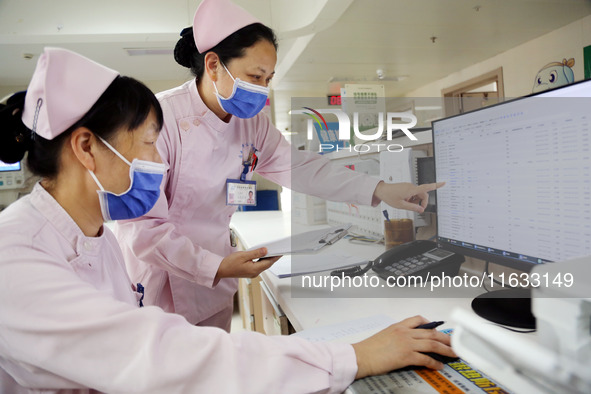 A medical staff member works at his post in the neonatology department of East Hospital in Lianyungang, China, on October 3, 2024. 