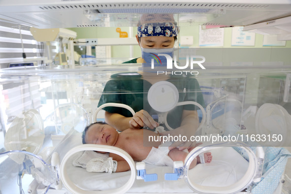 A medical staff member works at his post in the neonatology department of East Hospital in Lianyungang, China, on October 3, 2024. 