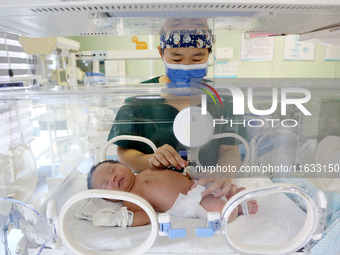 A medical staff member works at his post in the neonatology department of East Hospital in Lianyungang, China, on October 3, 2024. (