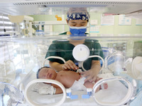 A medical staff member works at his post in the neonatology department of East Hospital in Lianyungang, China, on October 3, 2024. (