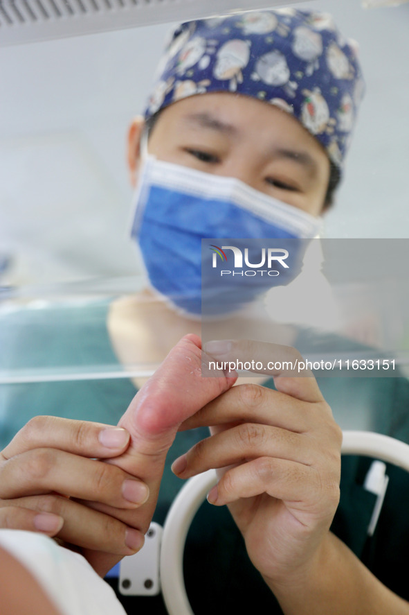 A medical staff member works at his post in the neonatology department of East Hospital in Lianyungang, China, on October 3, 2024. 