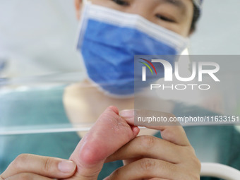 A medical staff member works at his post in the neonatology department of East Hospital in Lianyungang, China, on October 3, 2024. (