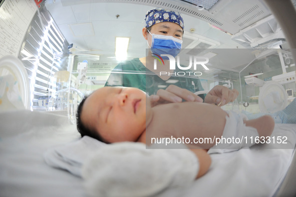 A medical staff member works at his post in the neonatology department of East Hospital in Lianyungang, China, on October 3, 2024. 