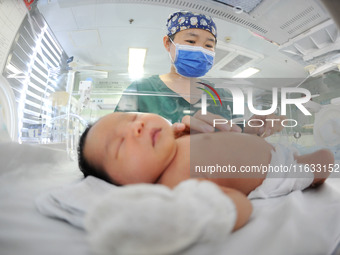 A medical staff member works at his post in the neonatology department of East Hospital in Lianyungang, China, on October 3, 2024. (