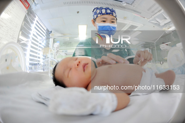 A medical staff member works at his post in the neonatology department of East Hospital in Lianyungang, China, on October 3, 2024. 