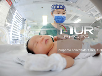 A medical staff member works at his post in the neonatology department of East Hospital in Lianyungang, China, on October 3, 2024. (