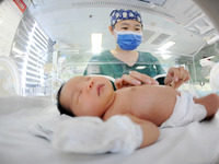 A medical staff member works at his post in the neonatology department of East Hospital in Lianyungang, China, on October 3, 2024. (