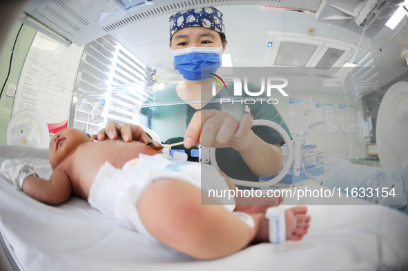 A medical staff member works at his post in the neonatology department of East Hospital in Lianyungang, China, on October 3, 2024. 