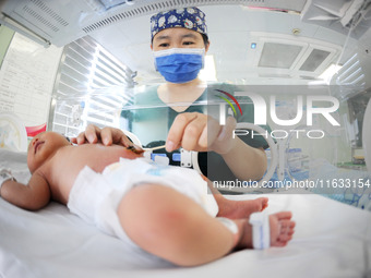 A medical staff member works at his post in the neonatology department of East Hospital in Lianyungang, China, on October 3, 2024. (