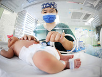 A medical staff member works at his post in the neonatology department of East Hospital in Lianyungang, China, on October 3, 2024. (