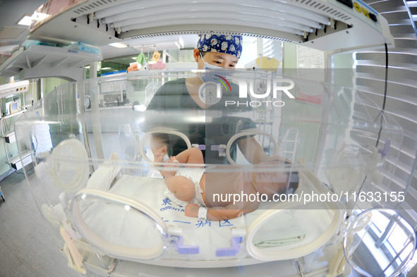 A medical staff member works at his post in the neonatology department of East Hospital in Lianyungang, China, on October 3, 2024. 