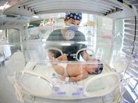 A medical staff member works at his post in the neonatology department of East Hospital in Lianyungang, China, on October 3, 2024. (