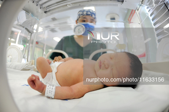 A medical staff member works at his post in the neonatology department of East Hospital in Lianyungang, China, on October 3, 2024. 