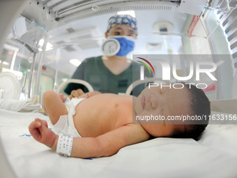 A medical staff member works at his post in the neonatology department of East Hospital in Lianyungang, China, on October 3, 2024. (