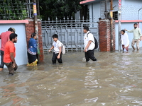 Vehicles and rickshaws try to drive with passengers through the waterlogged streets of Dhaka, Bangladesh, on October 3, 2024, after heavy mo...