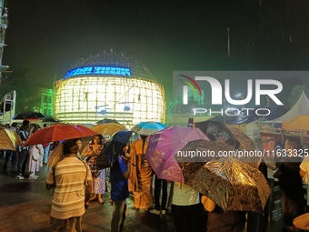 Visitor's Hold Umbrella Amid Heavy Rain And Visiting A Puja Pandal Ahead The Durga Puja Festival In Kolkata, India On October 3,2024.(