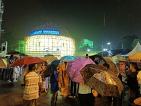 Visitor's Hold Umbrella Amid Heavy Rain And Visiting A Puja Pandal Ahead The Durga Puja Festival In Kolkata, India On October 3,2024.(