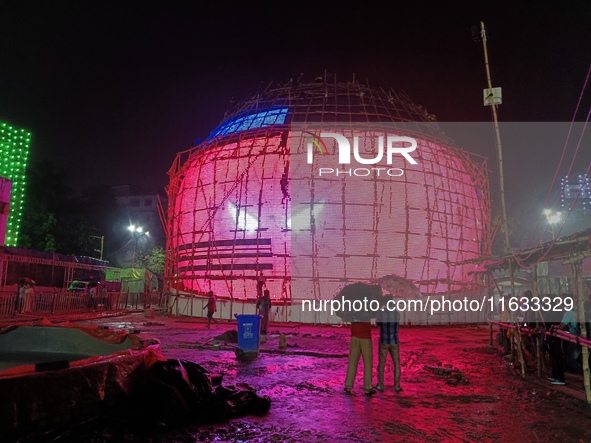 Visitor's Hold Umbrella Amid Heavy Rain And Visiting A Puja Pandal Ahead The Durga Puja Festival In Kolkata, India On October 3,2024.