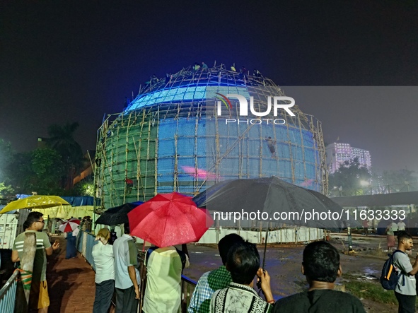 Visitor's Hold Umbrella Amid Heavy Rain And Visiting A Puja Pandal Ahead The Durga Puja Festival In Kolkata, India On October 3,2024.