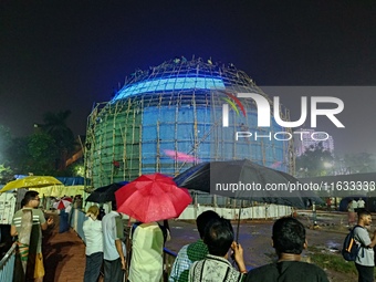 Visitor's Hold Umbrella Amid Heavy Rain And Visiting A Puja Pandal Ahead The Durga Puja Festival In Kolkata, India On October 3,2024.(