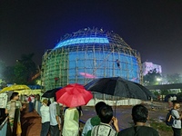 Visitor's Hold Umbrella Amid Heavy Rain And Visiting A Puja Pandal Ahead The Durga Puja Festival In Kolkata, India On October 3,2024.(