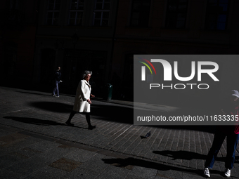 A person walks the street in Krakow, Poland on October 1, 2024. (