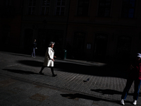 A person walks the street in Krakow, Poland on October 1, 2024. (