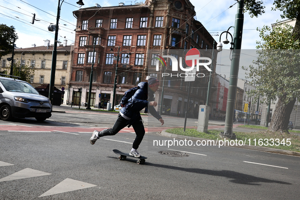 A person rides a skateboard on the street in Krakow, Poland on October 1, 2024. 