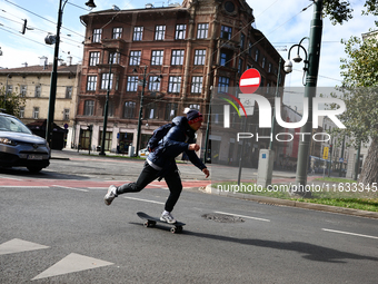 A person rides a skateboard on the street in Krakow, Poland on October 1, 2024. (