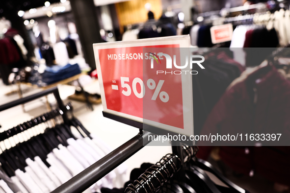 Mid season sale sign is seen in a clothing store in Krakow, Poland on October 2, 2024. 