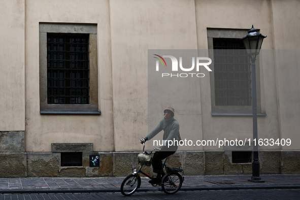 A person rides a bike in Krakow, Poland on October 3, 2024. 