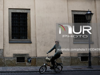 A person rides a bike in Krakow, Poland on October 3, 2024. (