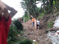 Villagers living in Laltong Village colony, approximately 20 km from Siliguri, carry their household items to a safer place in Laltong Villa...