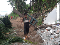 Villagers living in Laltong Village colony, approximately 20 km from Siliguri, carry their household items to a safer place in Laltong Villa...