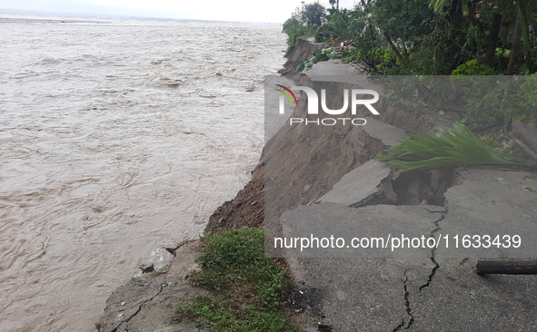 Villagers living in Laltong Village colony, approximately 20 km from Siliguri, carry their household items to a safer place in Laltong Villa...