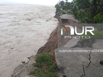 Villagers living in Laltong Village colony, approximately 20 km from Siliguri, carry their household items to a safer place in Laltong Villa...