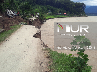 Villagers living in Laltong Village colony, approximately 20 km from Siliguri, carry their household items to a safer place in Laltong Villa...