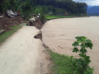 Villagers living in Laltong Village colony, approximately 20 km from Siliguri, carry their household items to a safer place in Laltong Villa...