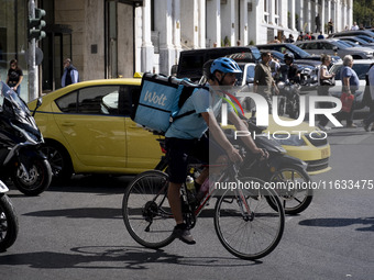 A Wolt delivery person rides a bicycle in the center of Athens, Greece, on October 3, 2024. Wolt is the second most popular delivery company...