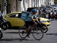 A Wolt delivery person rides a bicycle in the center of Athens, Greece, on October 3, 2024. Wolt is the second most popular delivery company...