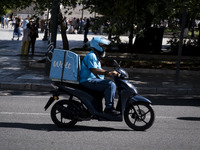 A Wolt delivery driver rides his motorcycle in the center of Athens, Greece, on October 3, 2024. Wolt is the second most popular delivery co...