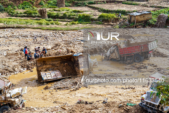 Flooding from the Salamdo River sweeps and damages a vehicle in Patikharka, Kavrepalanchok District, Nepal, on October 3, 2024. 